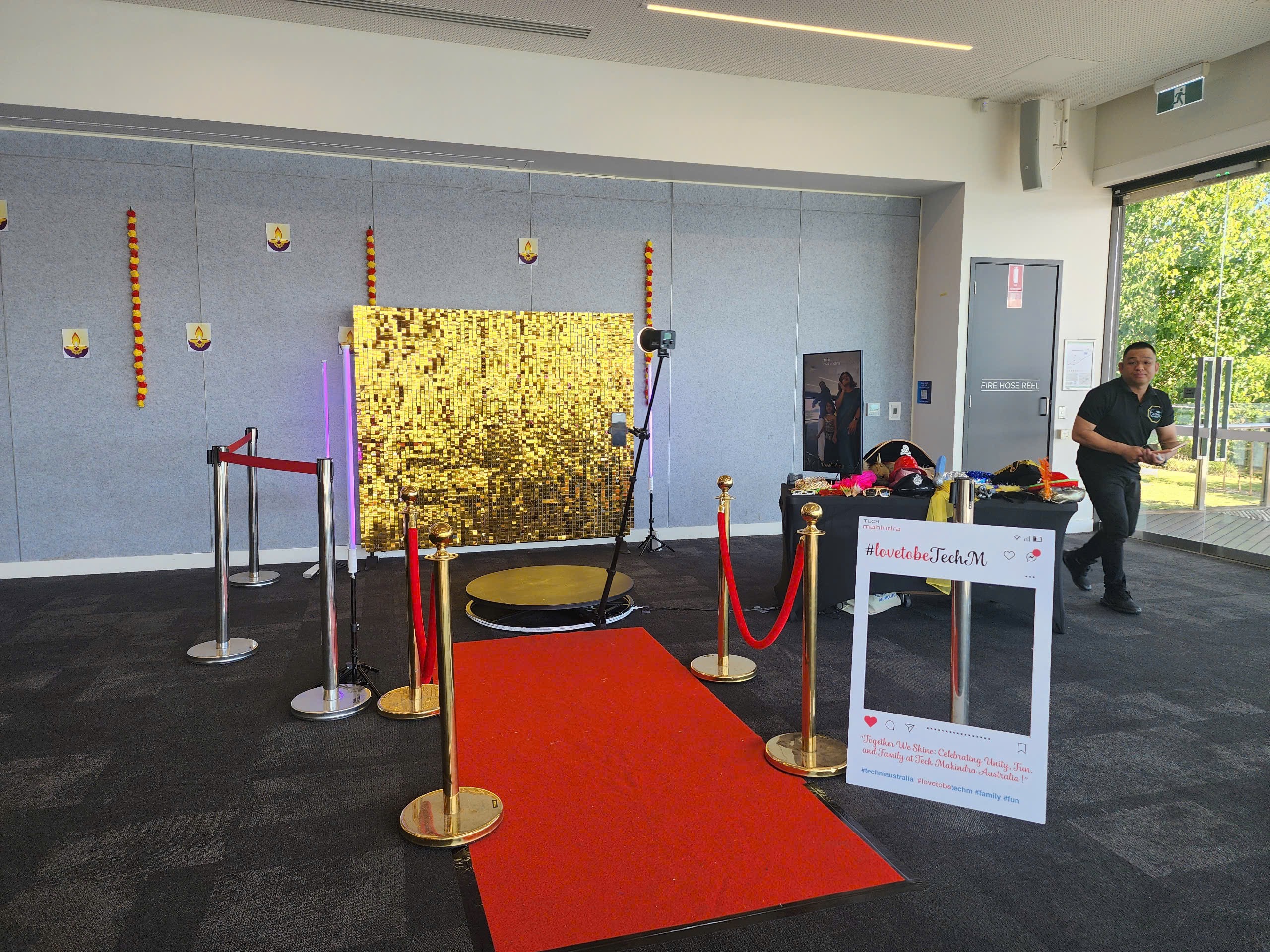 360 booth corporate event setup with gold backdrop